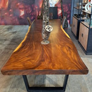 Organic Suar wood dining table seating 12, featuring a black steel base.