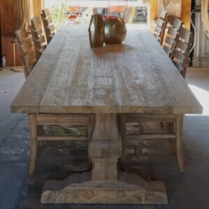 A large, elegant dining table made from recycled teak wood, suitable for both indoor and outdoor use. It comfortably seats 12 to 14 people, making it perfect for gatherings and family meals.